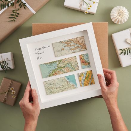 Five different map locations on white mount framed in white wood frame. Personalisation printed in top left hand corner of frame 'Happy memories were made here...'