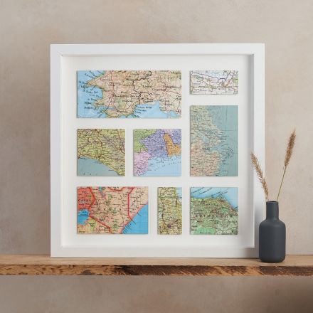Eight custom map locations mounted on white and framed in white wood frame.