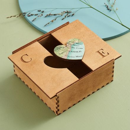 Handmade wooden keepsake box with map heart and initials engraved on top of box.
