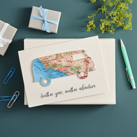Map location campervan on white card printed with 'another year, another adventure'.