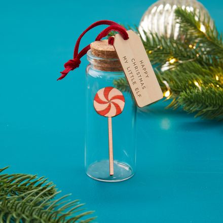 Glass bottle bauble Christmas decoration holding miniature candy lollipop