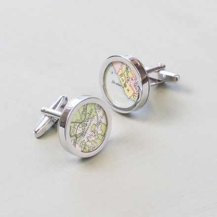 Silver cufflinks each showing a different map location.