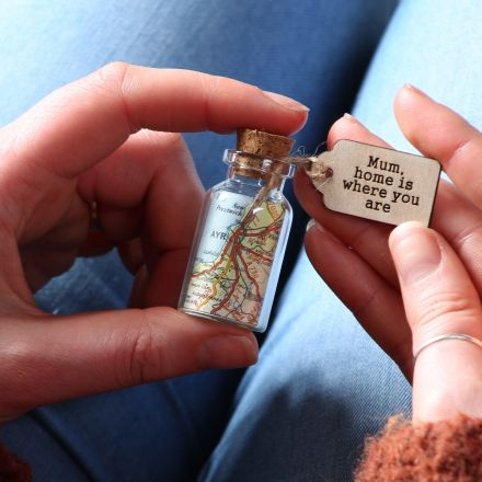 Personalised map in a miniature bottle keepsake with engraved wooden message tag reading 'Mum, home is where you are'