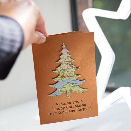 Copper coloured card featuring a map Christmas tree with 'Wishing you a happy Christmas Love from the Harpers' printed beneath.