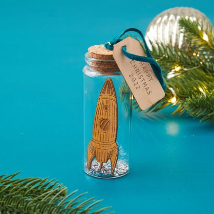 Glass bottle bauble Christmas decoration holding miniature space rocket