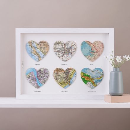 Six map heats in white wood frame. A few words chosen by customer printed under each heart and date printed down left side.