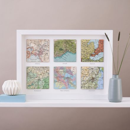 Six map location squares in white wood frame with printed personalisation under each square.