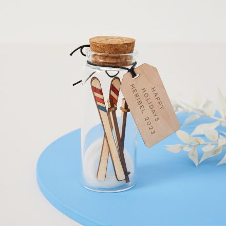 Miniature skis in a message bottle with engraved gift tag.