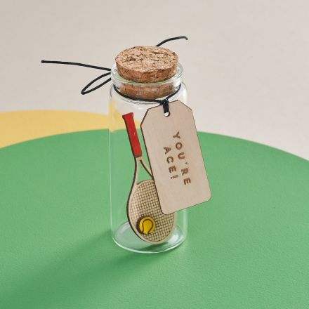 A miniature Tennis racket in a glass bottle. Personalised sport themed gift
