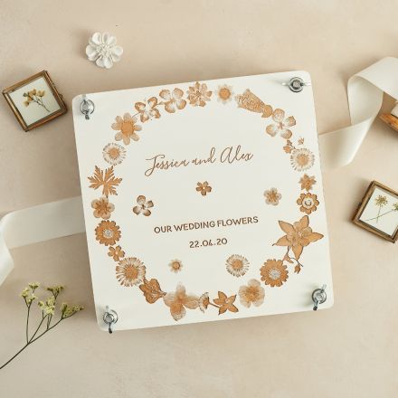 Large white painted wooden flower press engraved with pressed flower design and personalised with a couples names and wedding date.