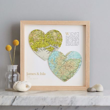 Two map hearts in light wood frame with added printed personalisation. Top right hand corner showing printed 'how we met' text and bottom left corner showing couples names and Est. date.