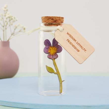 Miniature handpainted violet in a glass message bottle