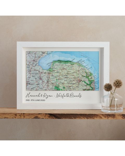 Landscape custom map of Norfolk, mounted on white card with 'Hannah & Ryan - Norfolk Borads, 2nd - 9th June 2020' printed beneath map. White wood frame.