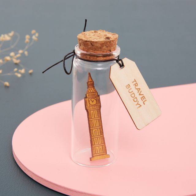 Miniature Big Ben dropped inside a glass bottle with engraved message tag.