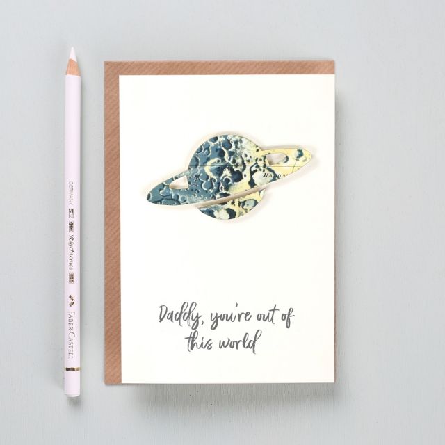 Silhouette of Saturn cut from original constellation map with 'Daddy you're out of this world' printed beneath.