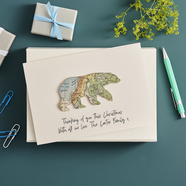 Polar bear cut from map and mounted on white card with 'Thinking of you this Christmas' printed beneath