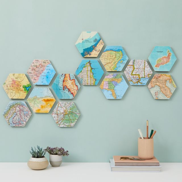 Ten map hexagons mounted on wall above mantelpiece.