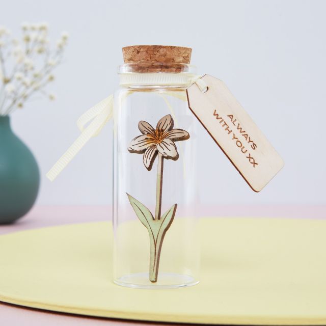 Miniature narcissus in a bottle with engraved message tag