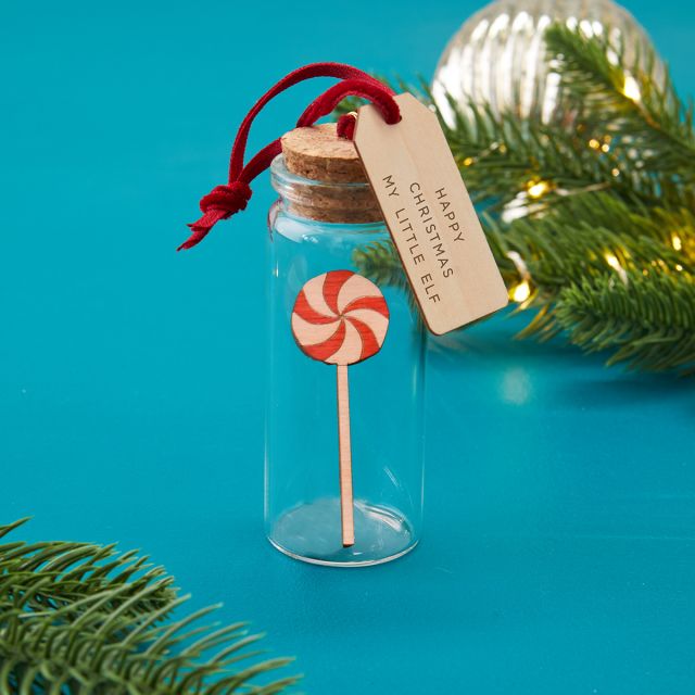 Glass bottle bauble Christmas decoration holding miniature candy lollipop