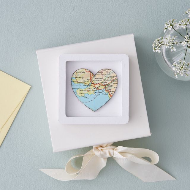 Map heart in a tiny black frame on top of gift box