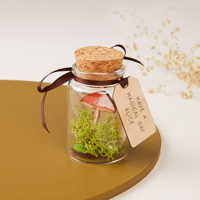 Miniature mushroom in glass bottle