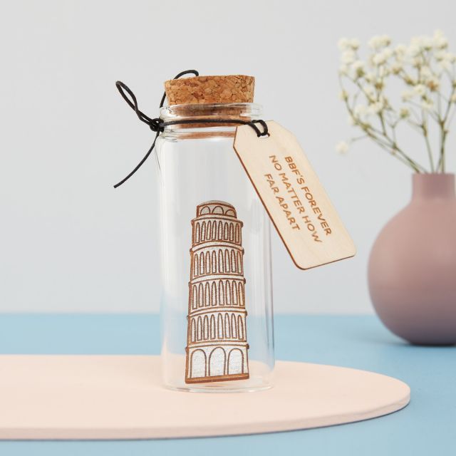 Miniature Tower of Pisa dropped inside a glass bottle with engraved message tag.