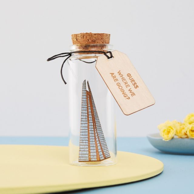 Miniature Shard dropped inside a glass bottle with engraved message tag.