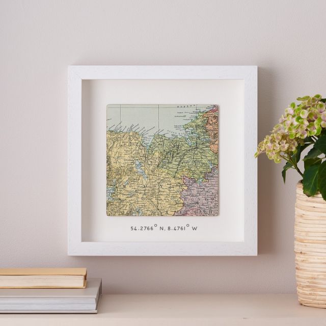 Square map framed in white box frame with printed coordinates beneath map.